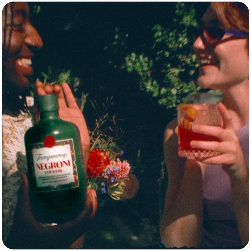 Two people enjoying a Tanqueray pre-mixed negroni cocktail